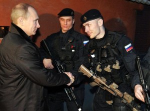Russia's Prime Minister Vladimir Putin (L) shakes hands with local Federal Security Service (FSB) special forces officers during a visit to the Chechnya's second-largest city, Gudermes, on December 20, 2011. The Federal Security Service (FSB) is the successor organisation -- responsible for internal security and intelligence -- to the feared Soviet-era KGB. AFP PHOTO/ RIA-NOVOSTI/ALEXEI NIKOLSKY